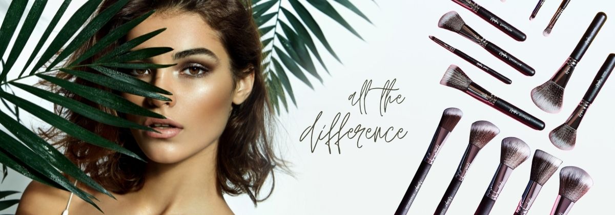 A woman grips a makeup brush and a lush palm leaf, symbolizing the harmony between beauty and the natural world.