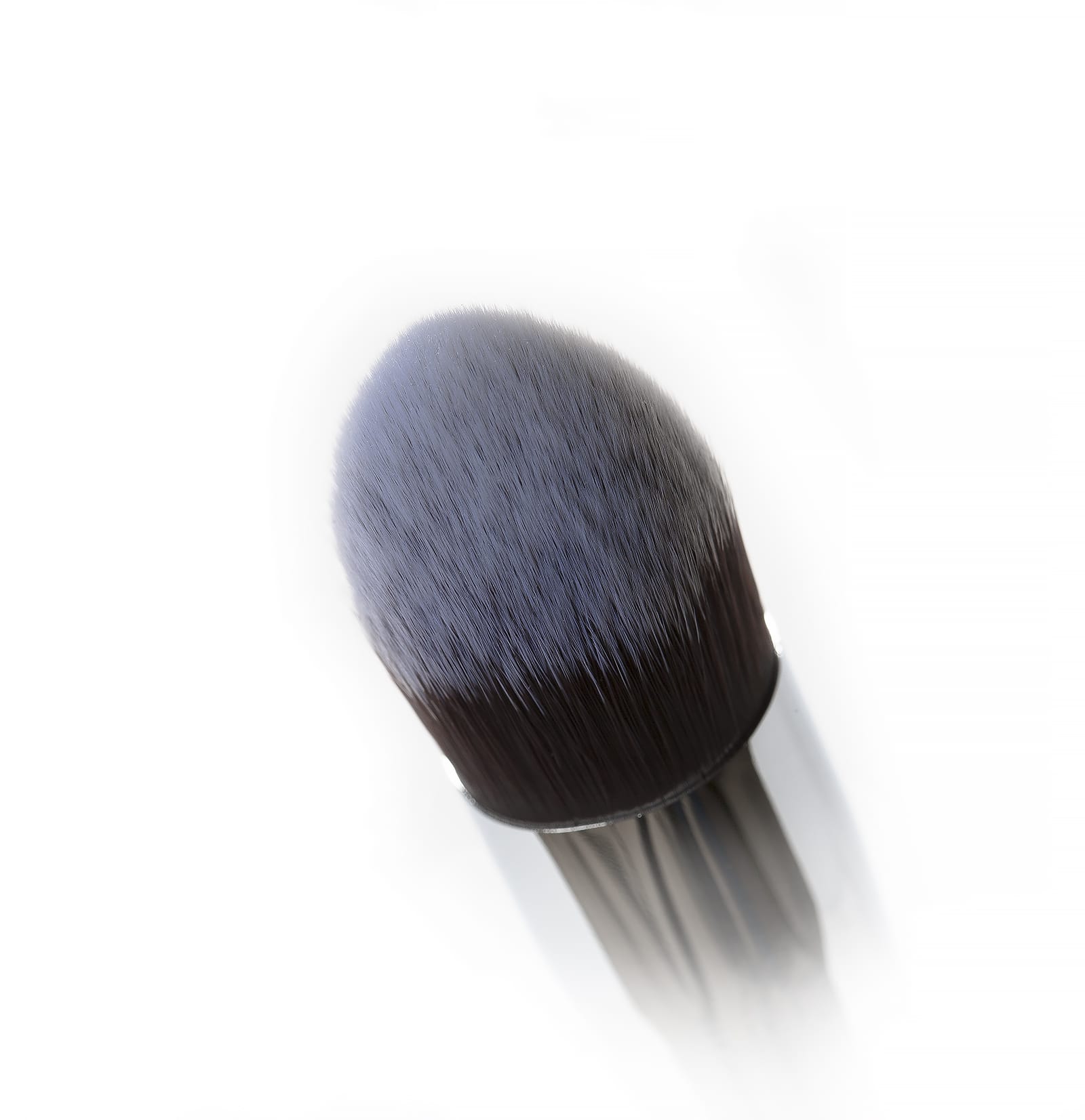 Close-up of the Nanshy Conceal Perfector brush with soft, pointed bristles designed for precise makeup application