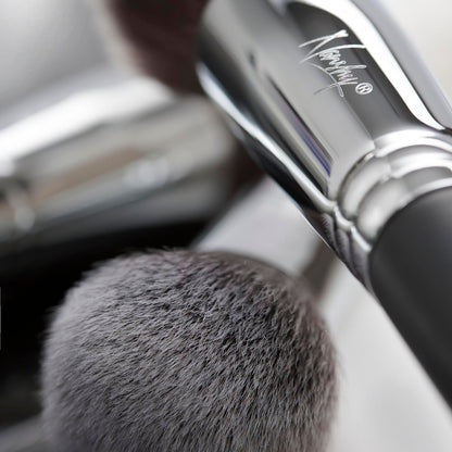 Close-up of a soft bristle makeup brush from the Masterful Collection by Nanshy, showcasing its sleek, cruelty-free design.