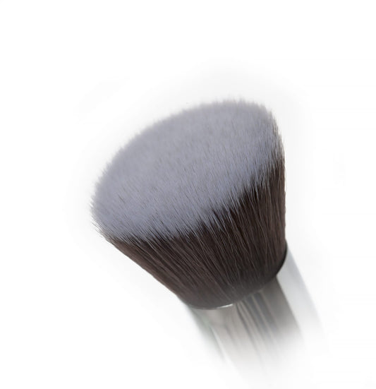 Two Nanshy Flawless Foundation makeup brushes with dense, soft taklon bristles, one with a white handle and one with a black handle, featuring engraved brass ferrules.